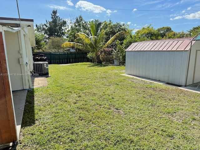 view of yard featuring cooling unit and a shed