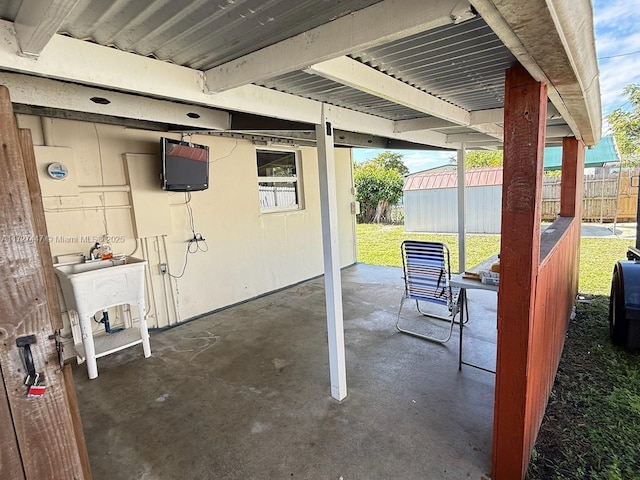 view of patio / terrace featuring a storage unit and sink