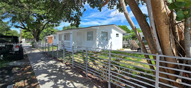 view of property exterior with a fenced front yard