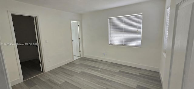 unfurnished bedroom featuring baseboards and wood finished floors