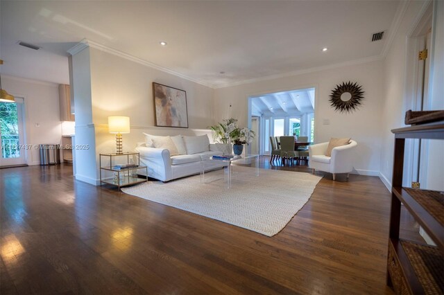 living room with dark wood-type flooring and ornamental molding