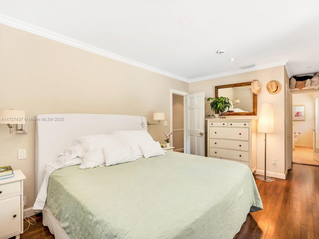 bedroom featuring dark hardwood / wood-style floors and crown molding