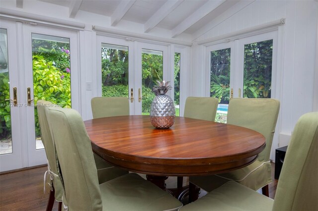 dining room with vaulted ceiling with beams, french doors, plenty of natural light, and dark hardwood / wood-style flooring