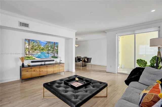 living room featuring ornamental molding and light hardwood / wood-style floors