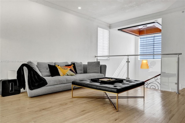 living room with light hardwood / wood-style floors and ornamental molding