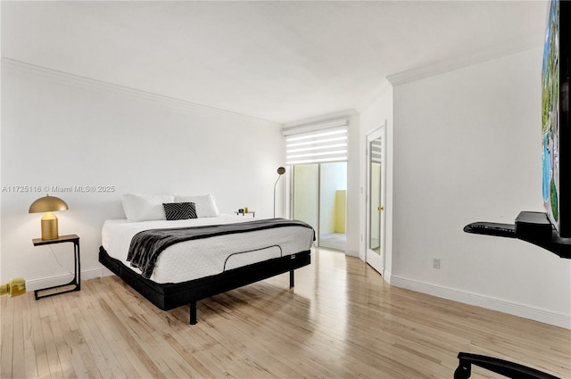 bedroom featuring light hardwood / wood-style flooring and crown molding