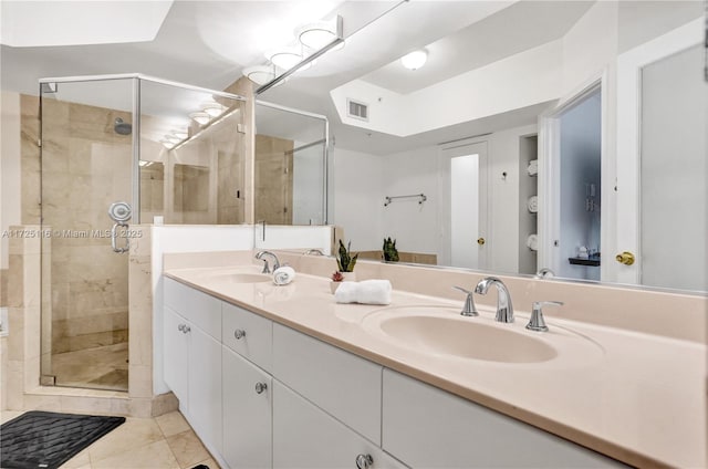 bathroom featuring vanity, tile patterned flooring, and an enclosed shower