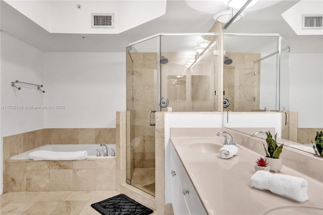 bathroom featuring tile patterned flooring, shower with separate bathtub, and vanity