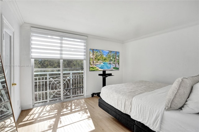 bedroom with ornamental molding and light wood-type flooring