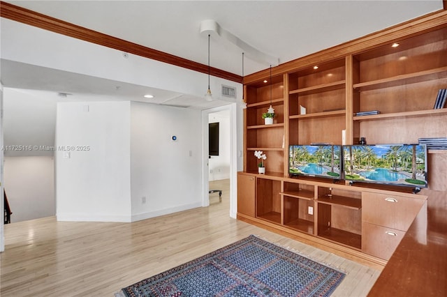 unfurnished office featuring crown molding and light hardwood / wood-style flooring