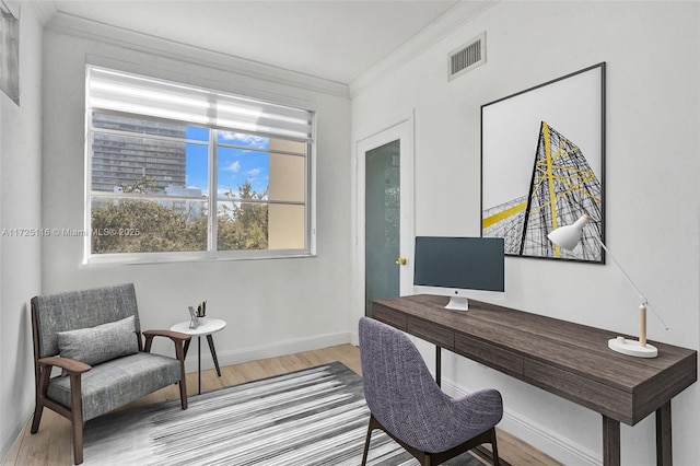 office featuring ornamental molding and light hardwood / wood-style floors