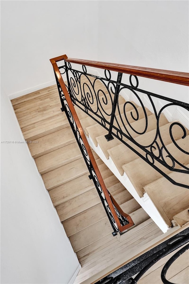 staircase featuring wood-type flooring