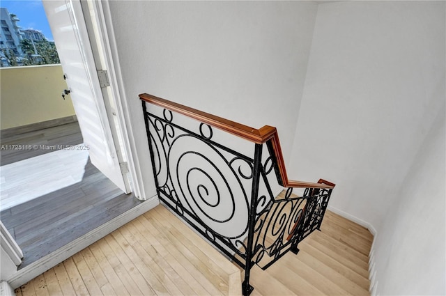 staircase featuring wood-type flooring