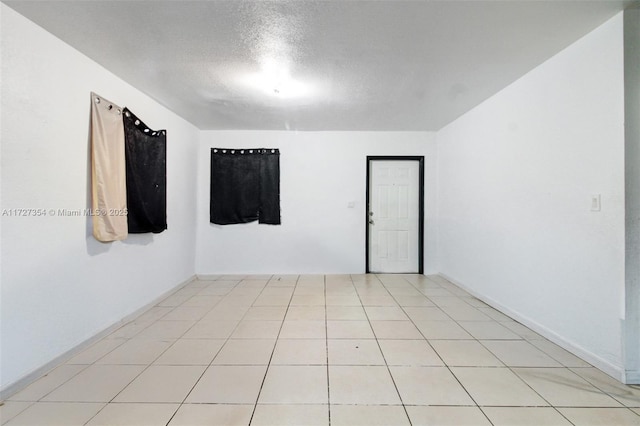 unfurnished room with a textured ceiling