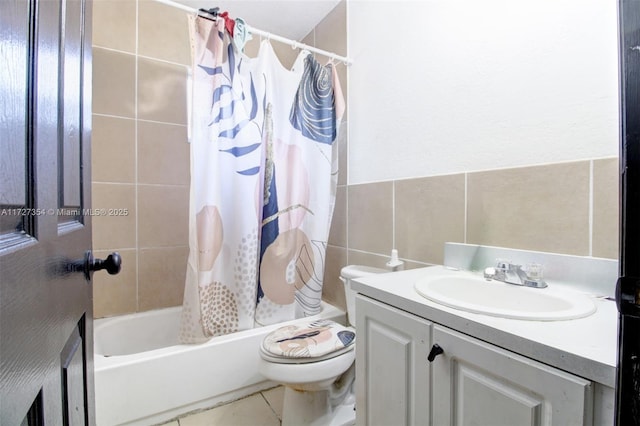 full bathroom featuring toilet, shower / tub combo with curtain, tile walls, tile patterned floors, and vanity