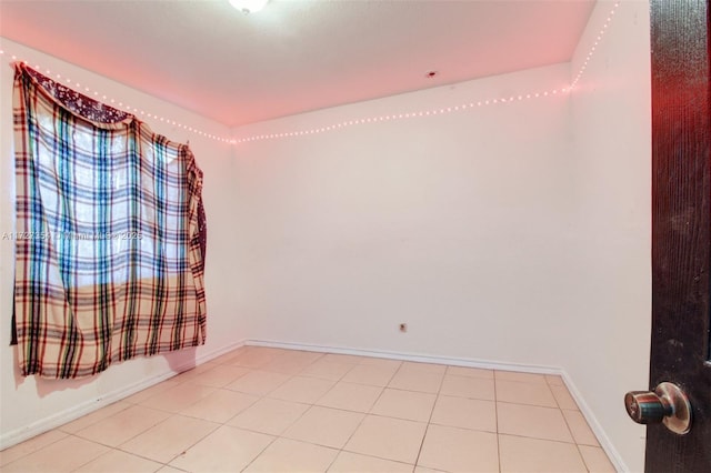 unfurnished room featuring light tile patterned floors