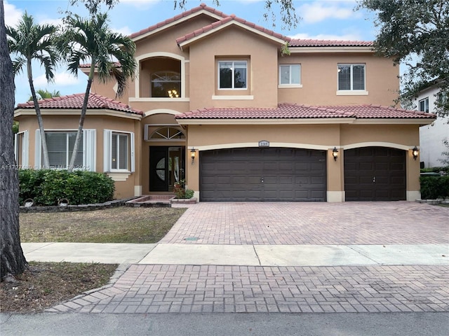 mediterranean / spanish house featuring a garage