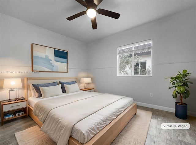 bedroom featuring ceiling fan, ornamental molding, and hardwood / wood-style flooring