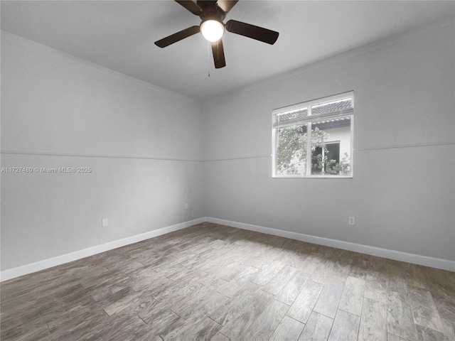 empty room featuring ceiling fan, ornamental molding, and wood-type flooring