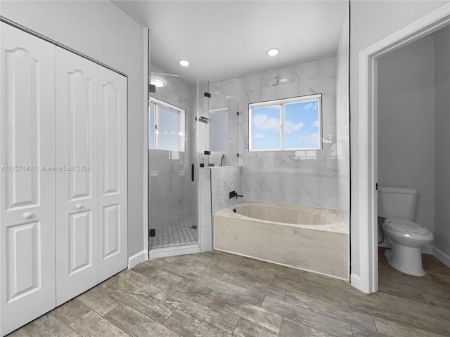 bathroom with toilet and separate shower and tub