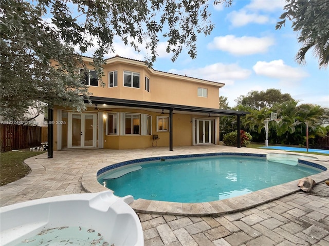 view of pool featuring french doors and a patio