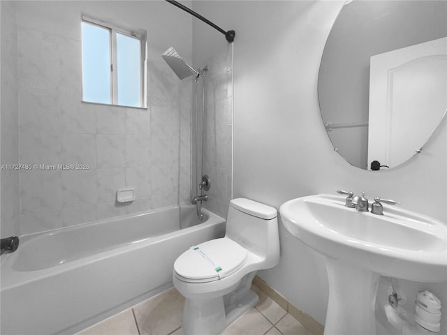 full bathroom with toilet, tiled shower / bath, sink, and tile patterned floors