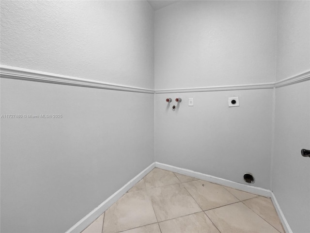 clothes washing area with washer hookup, light tile patterned flooring, and electric dryer hookup