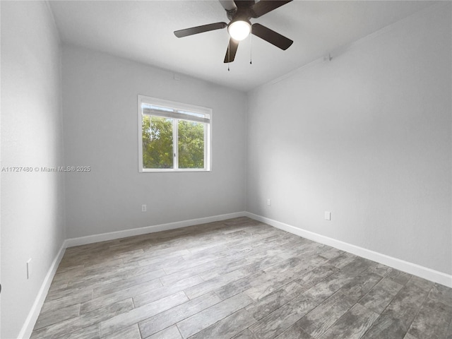 empty room with ceiling fan and light hardwood / wood-style flooring