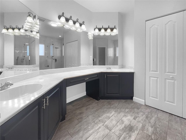 bathroom with vanity and a shower with door