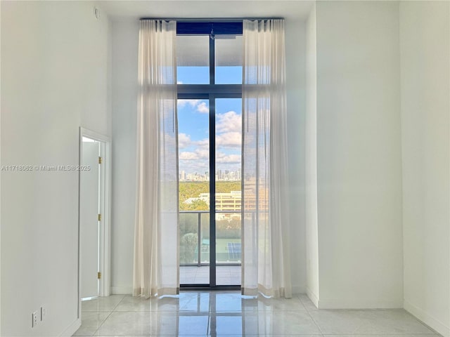 tiled spare room with a wealth of natural light