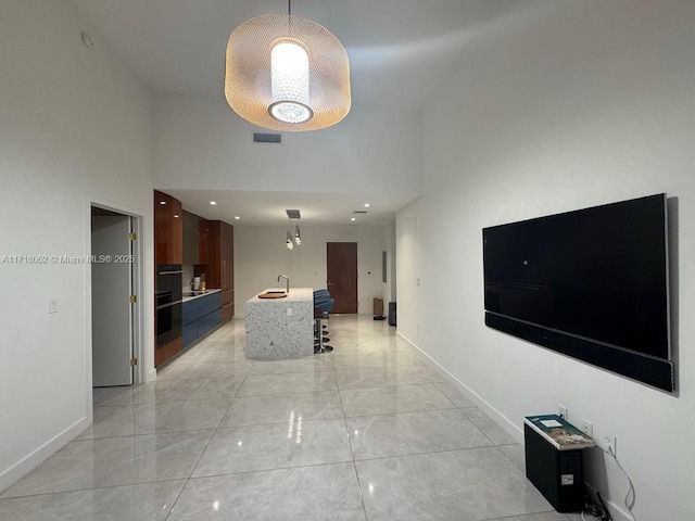 corridor with a towering ceiling and sink