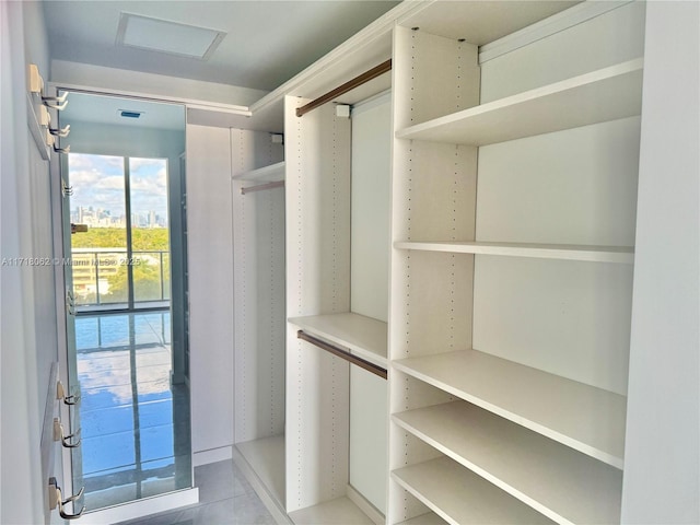 walk in closet featuring light tile patterned flooring