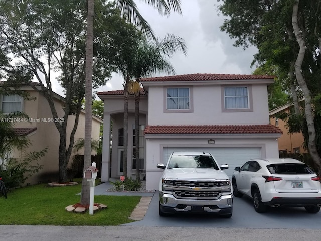 mediterranean / spanish house featuring a garage