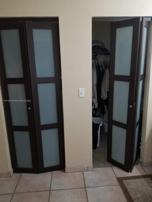 hall featuring light tile patterned flooring