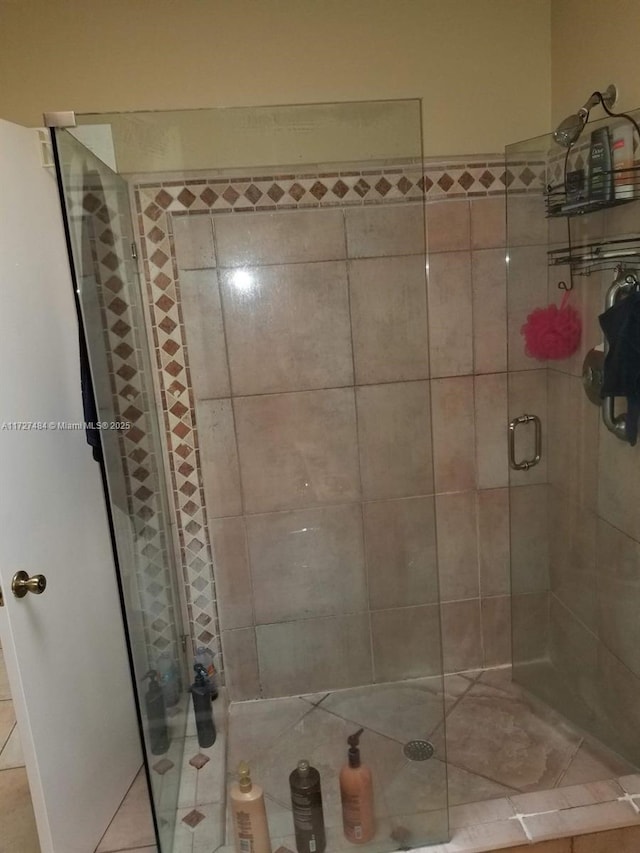 bathroom with tile patterned floors and an enclosed shower