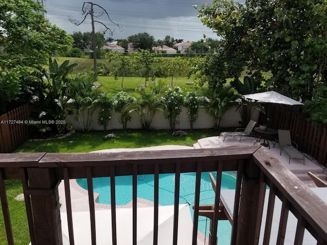 view of pool with a lawn