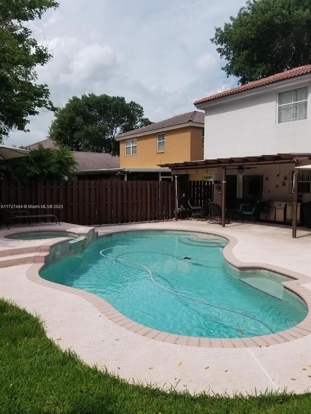 view of pool featuring a patio area and an in ground hot tub