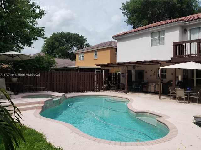 view of swimming pool with an in ground hot tub and a patio