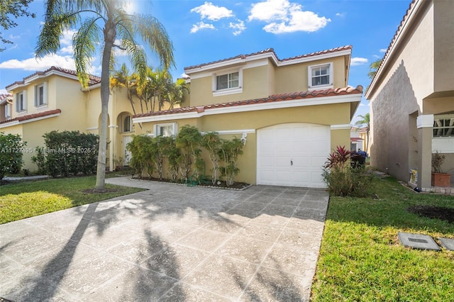 mediterranean / spanish house with a front yard and a garage