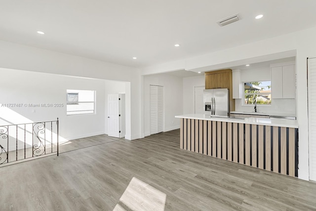 interior space with sink and light hardwood / wood-style floors