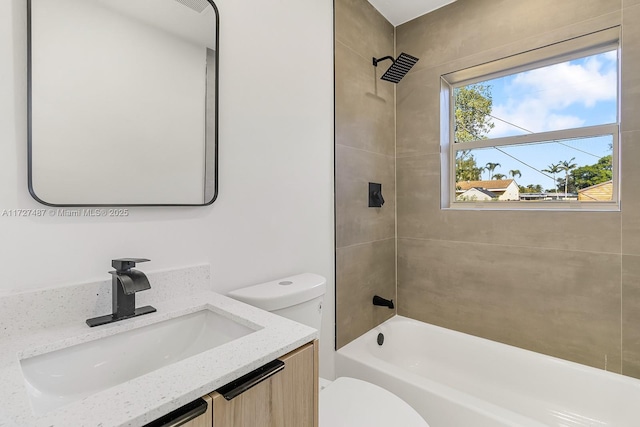 full bathroom featuring toilet, tiled shower / bath combo, and vanity