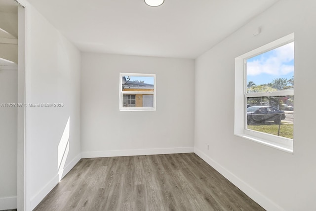 unfurnished room with wood-type flooring