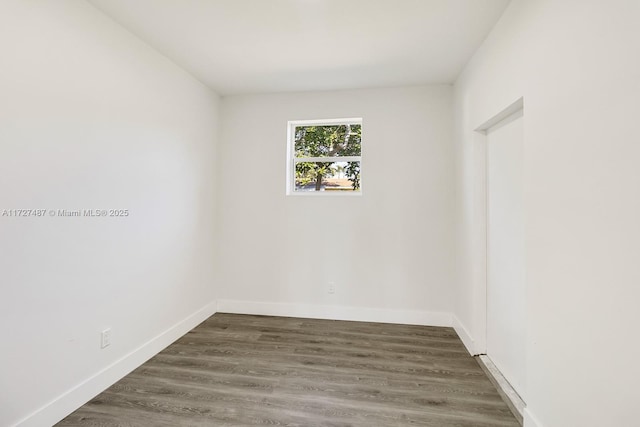 unfurnished room with dark hardwood / wood-style flooring