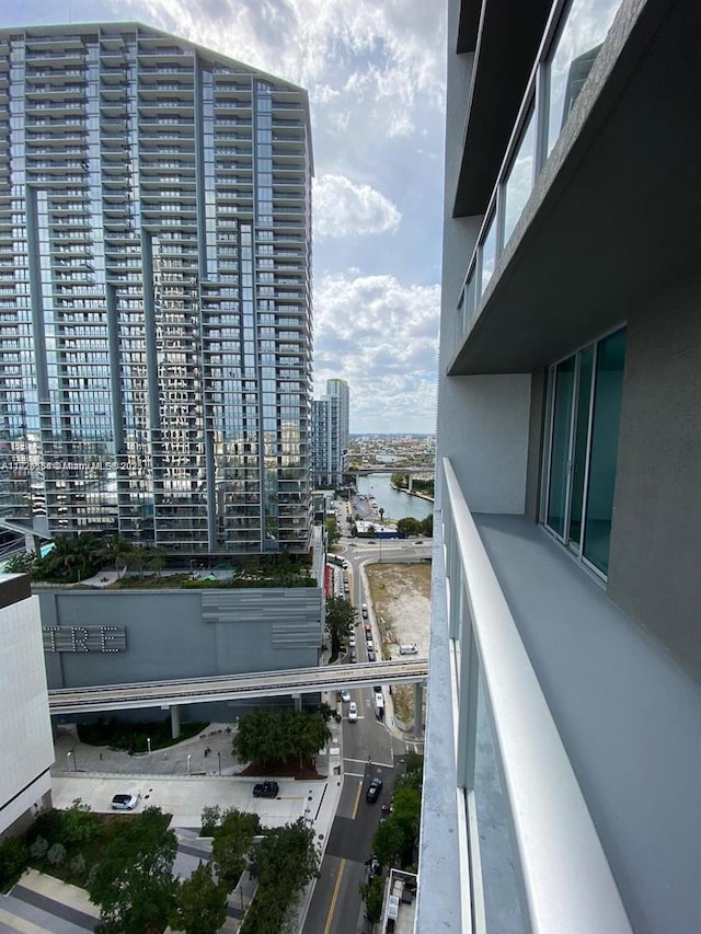 balcony with a water view and a city view