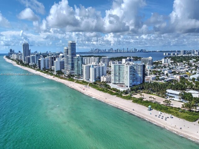 drone / aerial view featuring a view of the beach and a water view