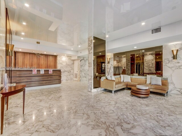 kitchen featuring stainless steel appliances, white cabinetry, sink, and a breakfast bar area