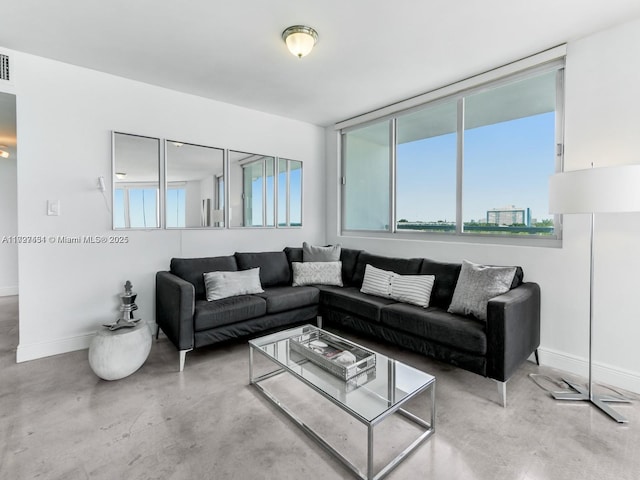 living room featuring concrete flooring