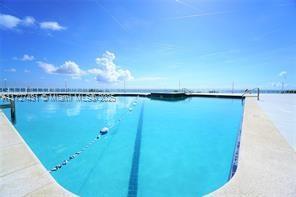 view of swimming pool featuring a water view