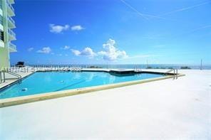 view of pool featuring a water view