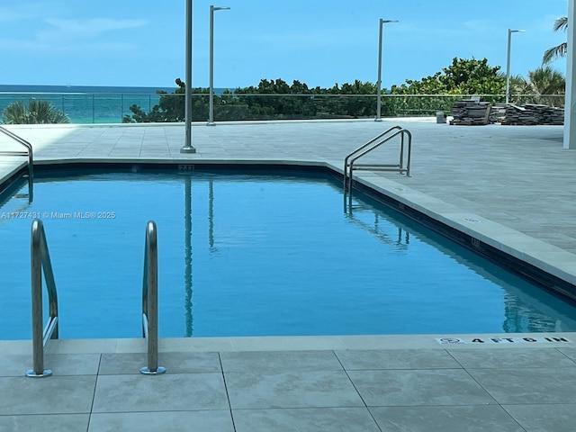 view of pool with a water view